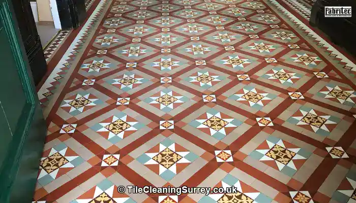 Caring for Victorian Tiles in Surrey to Preserve Heritage: Original Victorian floor tiles in a Surrey hallway showing age, patina, and wear.